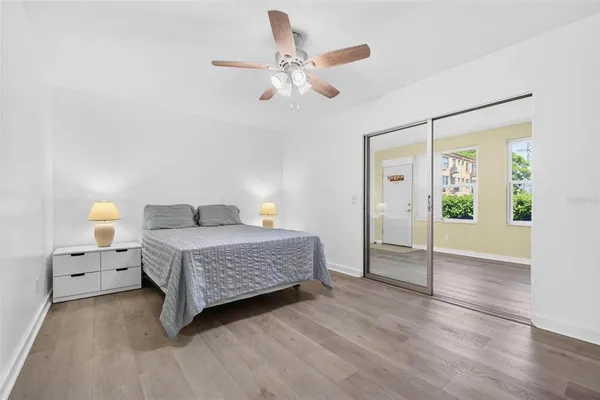 an empty room with windows and closet