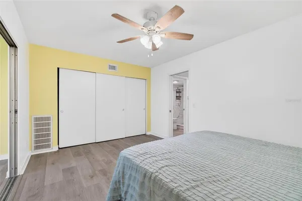 an empty room with wooden floor and entrance