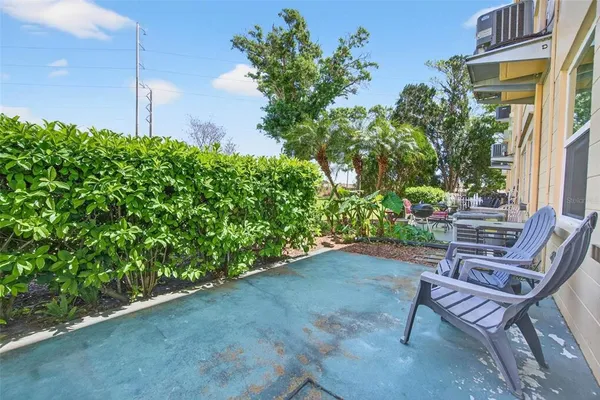 a backyard of a house with table and chairs