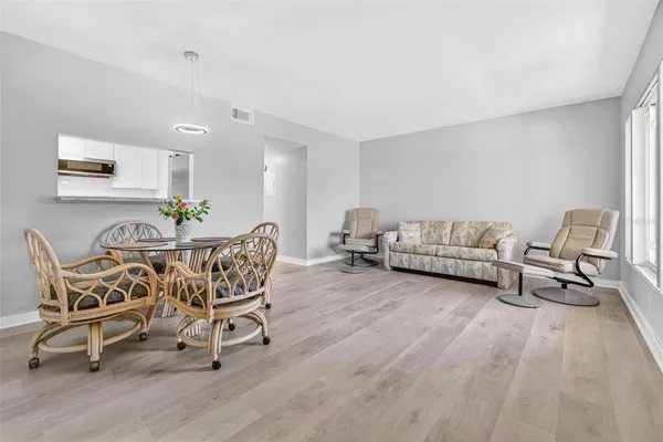 a view of a dining room with furniture and wooden floor