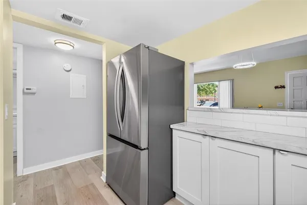 a kitchen with stainless steel appliances a stove microwave and a refrigerator