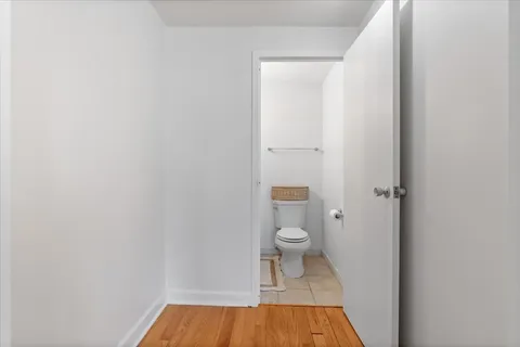 a bathroom with a toilet and a shower