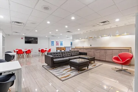 a living room with furniture and a rug