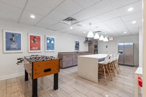 a large kitchen with a table and chairs