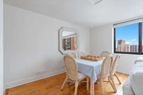 a dining room with furniture and window