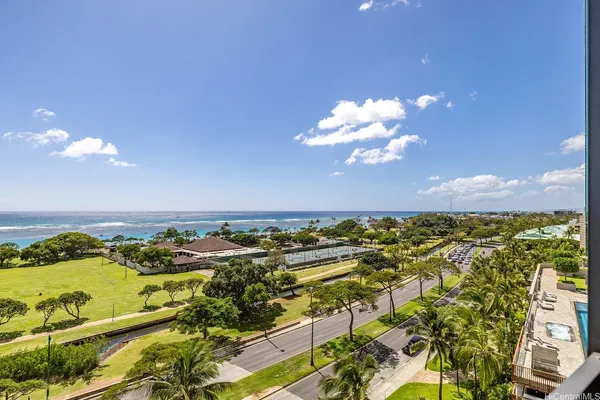 a view of a kitchen with furniture and wooden floor