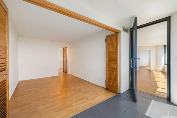 a bathroom with a granite countertop bathtub sink vanity mirror and toilet