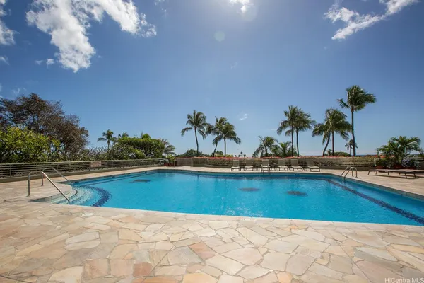 a swimming pool with outdoor seating