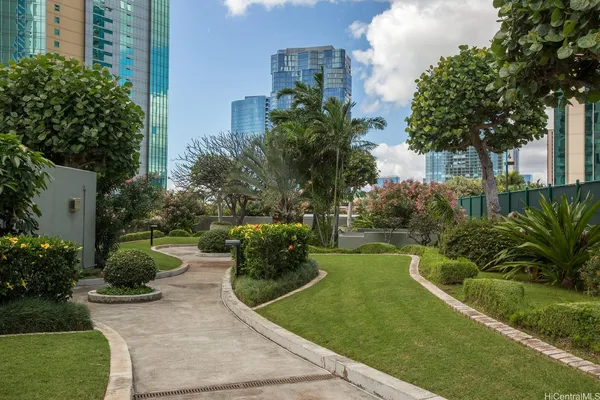 a view of a garden with tall buildings