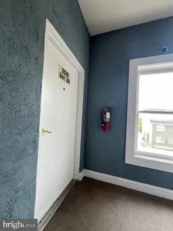 an empty room with furniture and a window