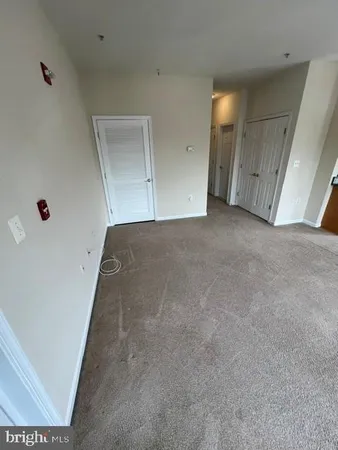 an empty room with an entrance and mirror