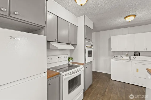 a kitchen with a sink a stove and cabinets