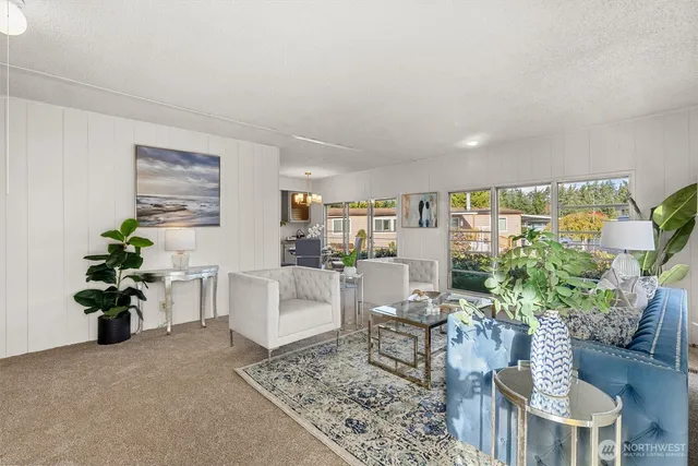 a living room with furniture and a potted plant