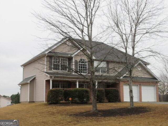 a front view of a house with a yard