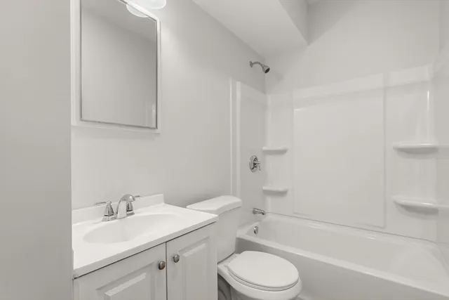 a bathroom with a sink toilet vanity and shower