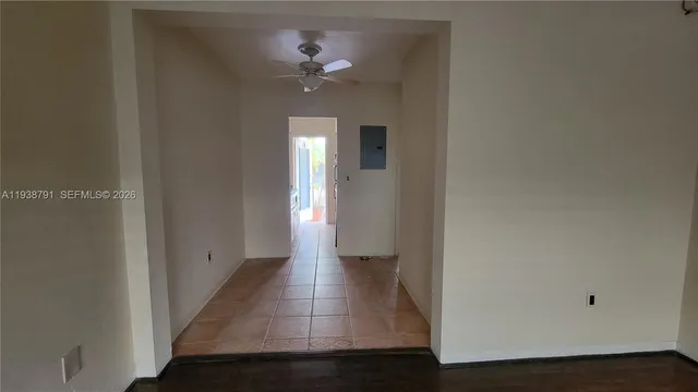 a entryway with flower plants and wooden walls