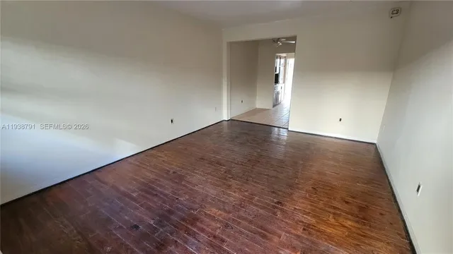wooden floor in a hall with an empty room