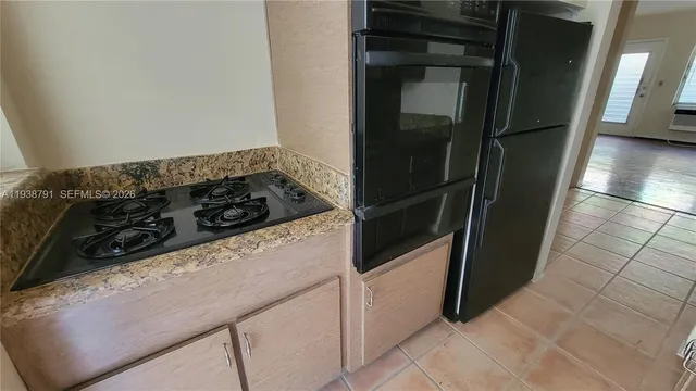 a kitchen with a refrigerator and a stove