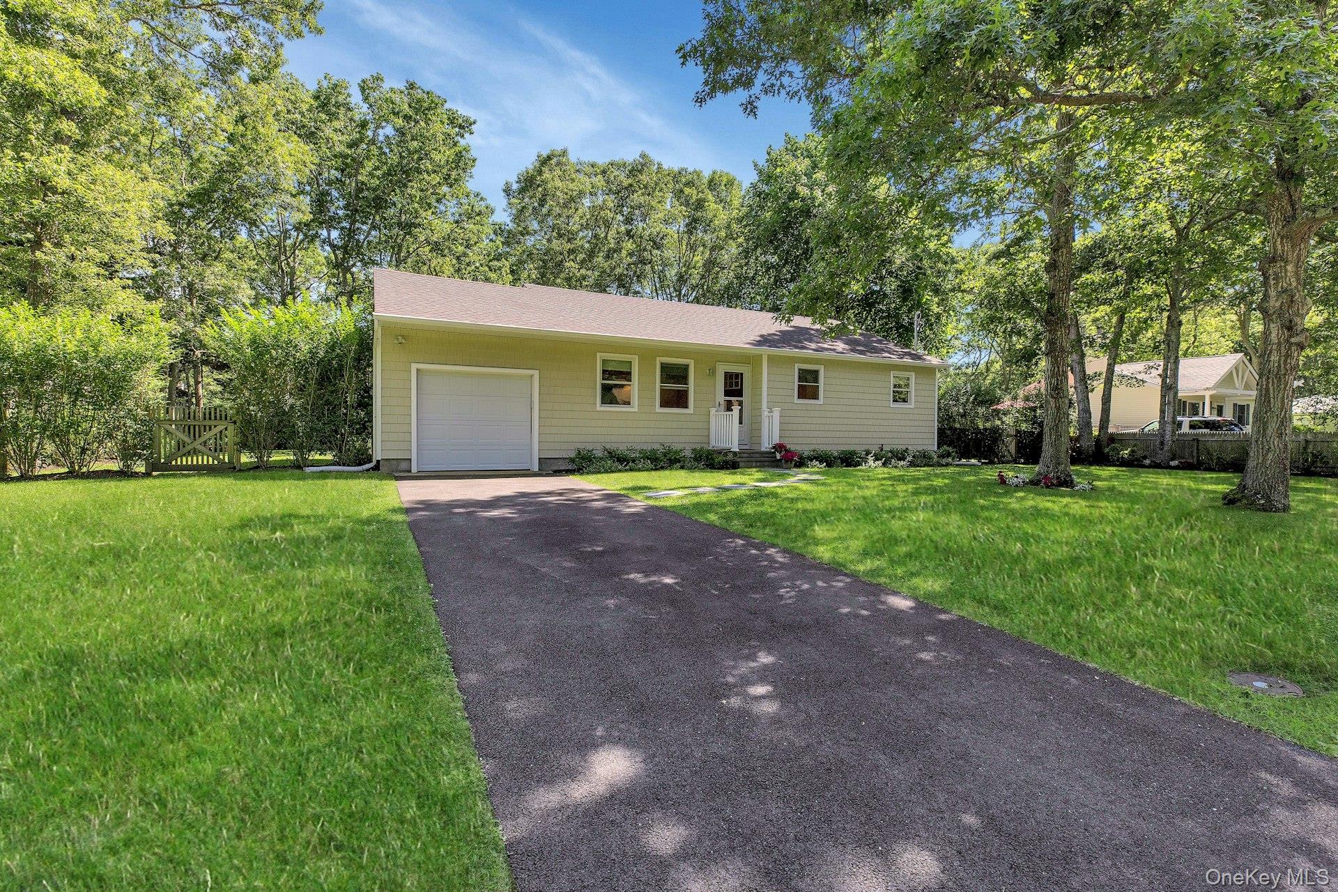 38 Woodridge Road Hampton Bays, NY 11946 - Photo 19 of 24 a front view of house with yard and green space
