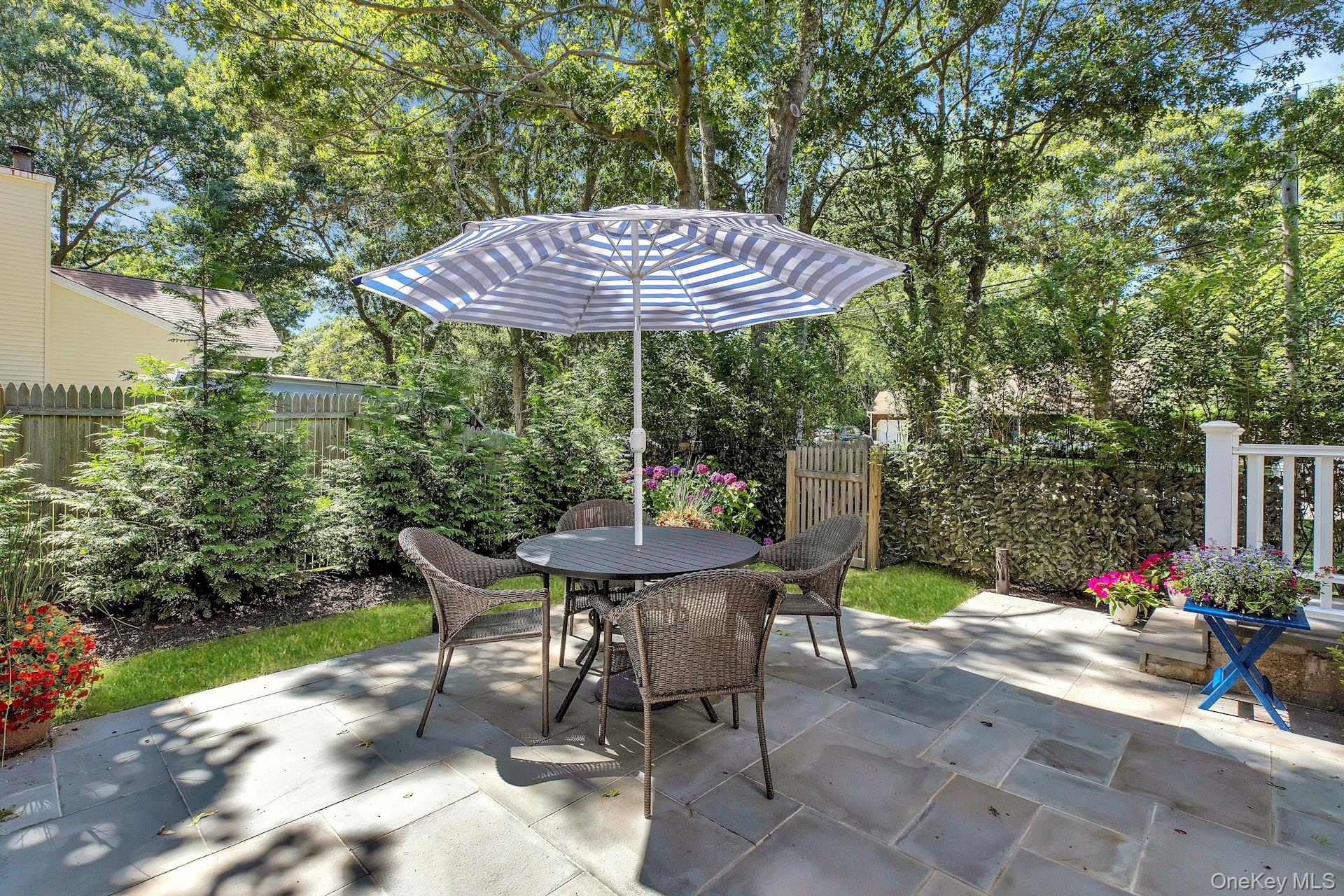 38 Woodridge Road Hampton Bays, NY 11946 - Photo 21 of 24 a view of a table and chairs in patio