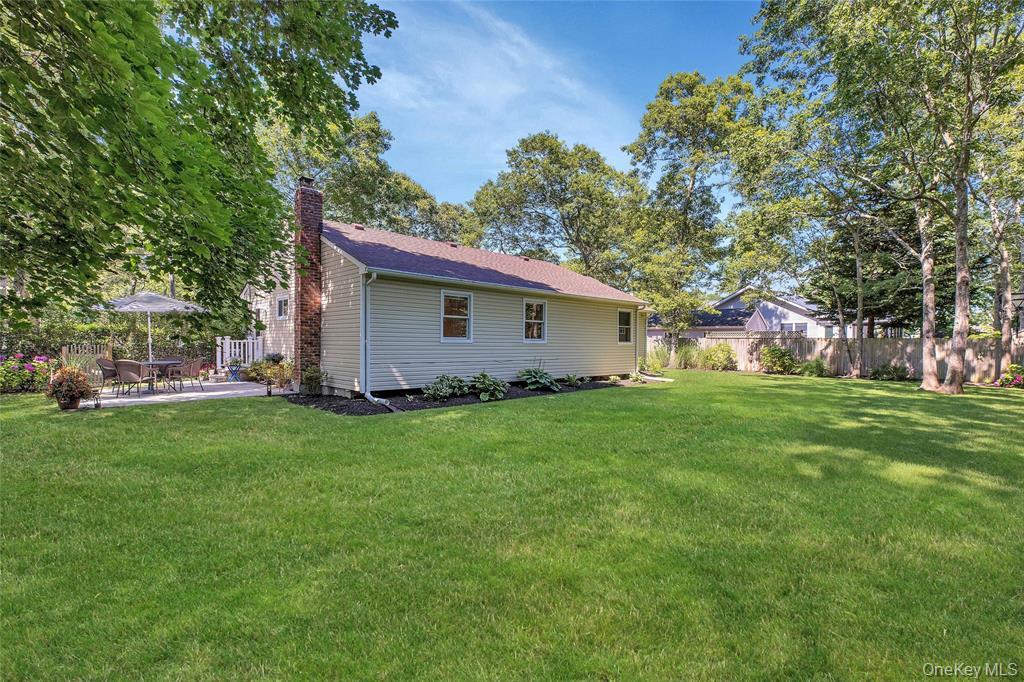 38 Woodridge Road Hampton Bays, NY 11946 - Photo 22 of 24 a view of a house with backyard and garden