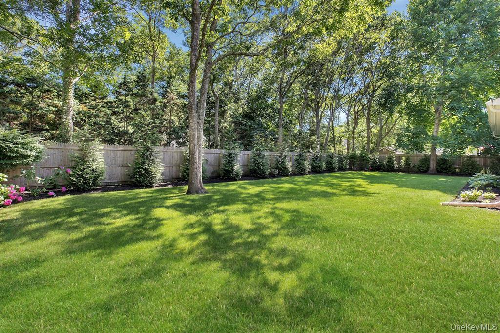 38 Woodridge Road Hampton Bays, NY 11946 - Photo 23 of 24 a view of a backyard with a garden