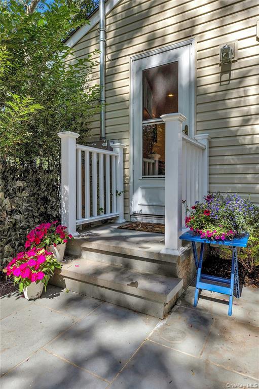 38 Woodridge Road Hampton Bays, NY 11946 - Photo 24 of 24 a view of a chair and tables in the back yard of the house