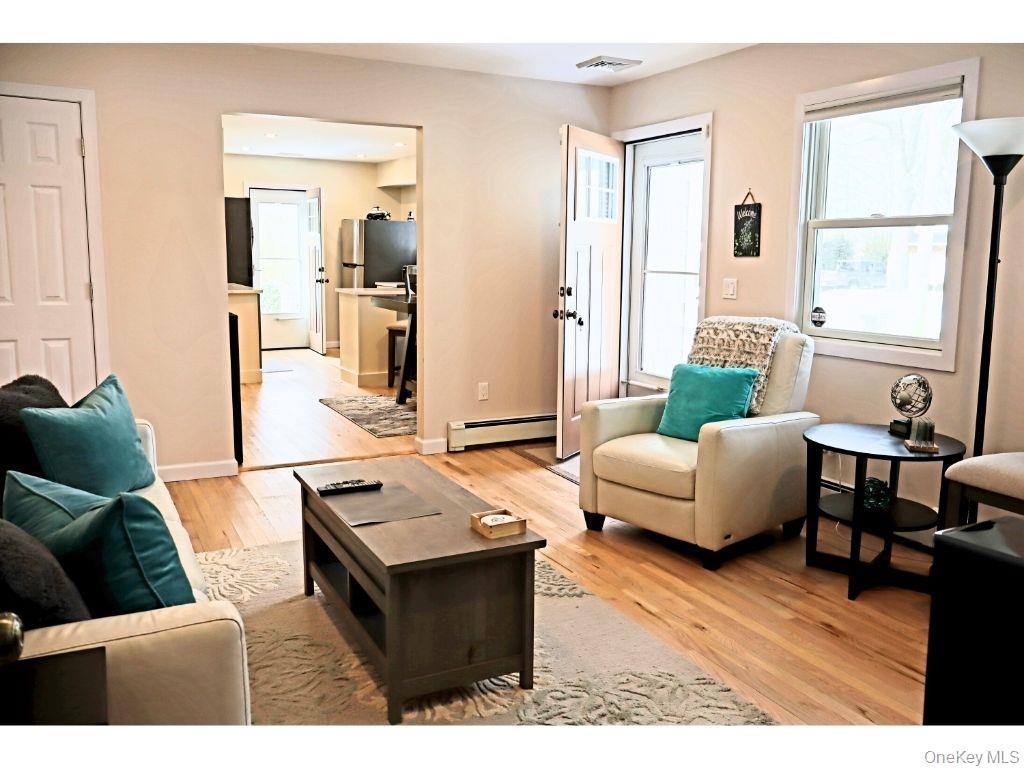 38 Woodridge Road Hampton Bays, NY 11946 - Photo 3 of 24 a living room with furniture and a large window