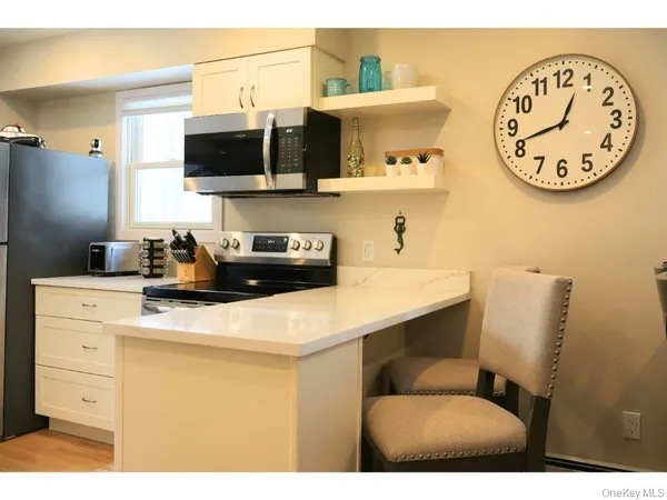 a kitchen with a sink cabinets and a clock