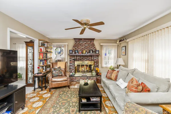 a living room with furniture fireplace and flat screen tv