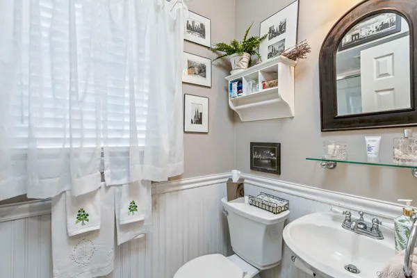 a bathroom with a sink a toilet and mirror