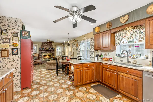 a kitchen with a sink a counter top space appliances and cabinets