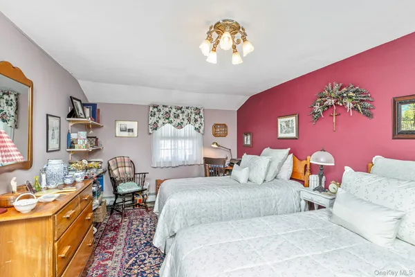 a bedroom with furniture and a chandelier