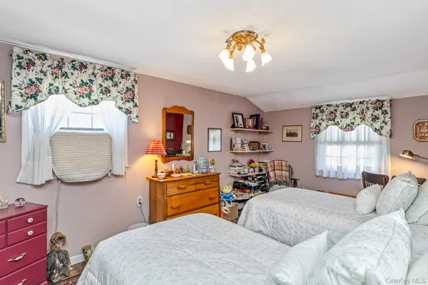 a bedroom with furniture and a wooden floor