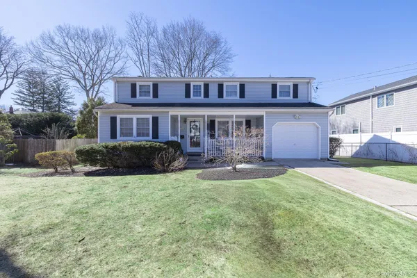 a front view of a house with patio and yard