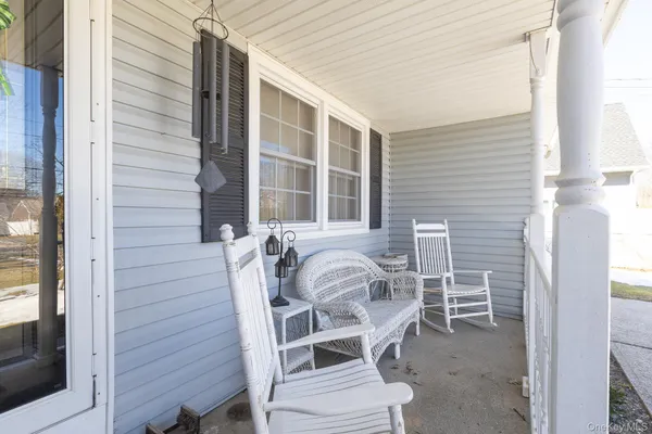 a view of a chair and table in the balcony