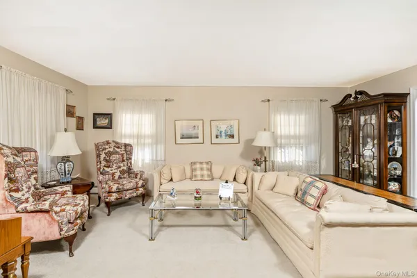 a living room with furniture and large window