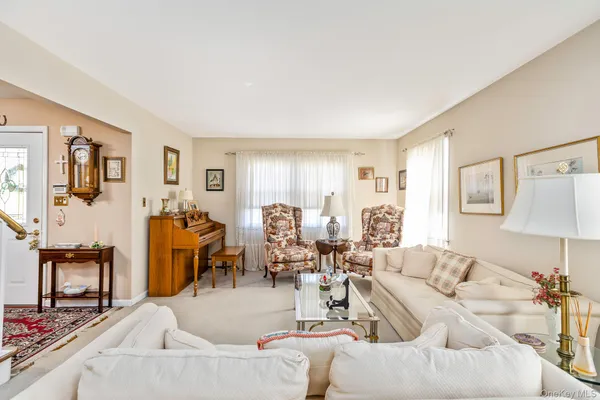 a living room with furniture and a lamp