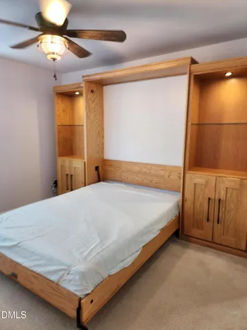 a bed sitting in a bedroom next to a window