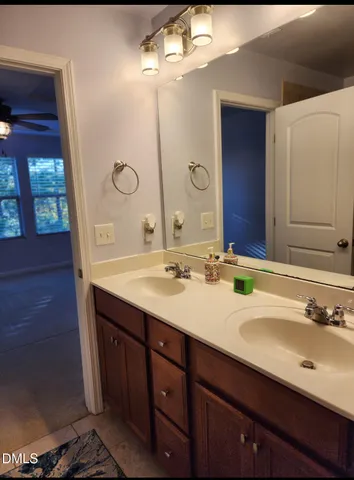 a bathroom with a double vanity sink and a mirror