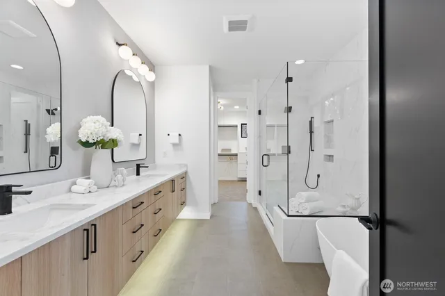 a spacious bathroom with a double vanity sink mirror double and shower