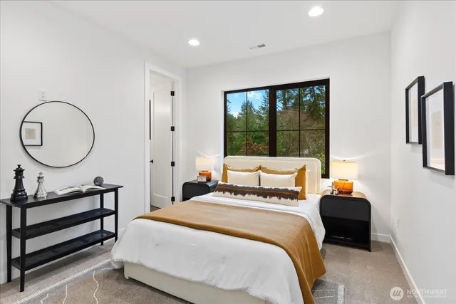 a bedroom with a bed a mirror and a window