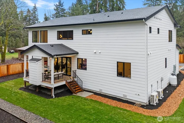 a view of a house with a yard and deck