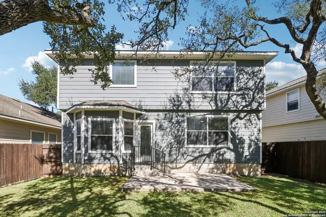 a view of a house with a yard and sitting area