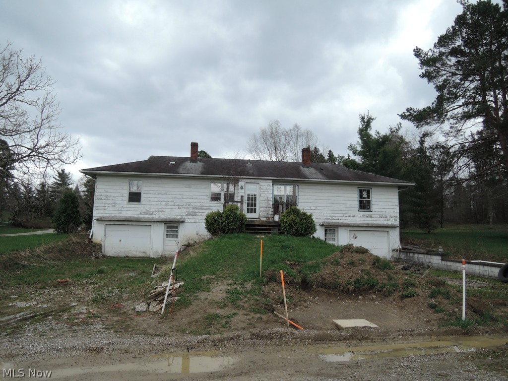 7932 Dines Road Novelty, OH 44072 - Photo 2 of 7 Back view of the house. Four bedrooms, 2 full baths, two 1 car garages.