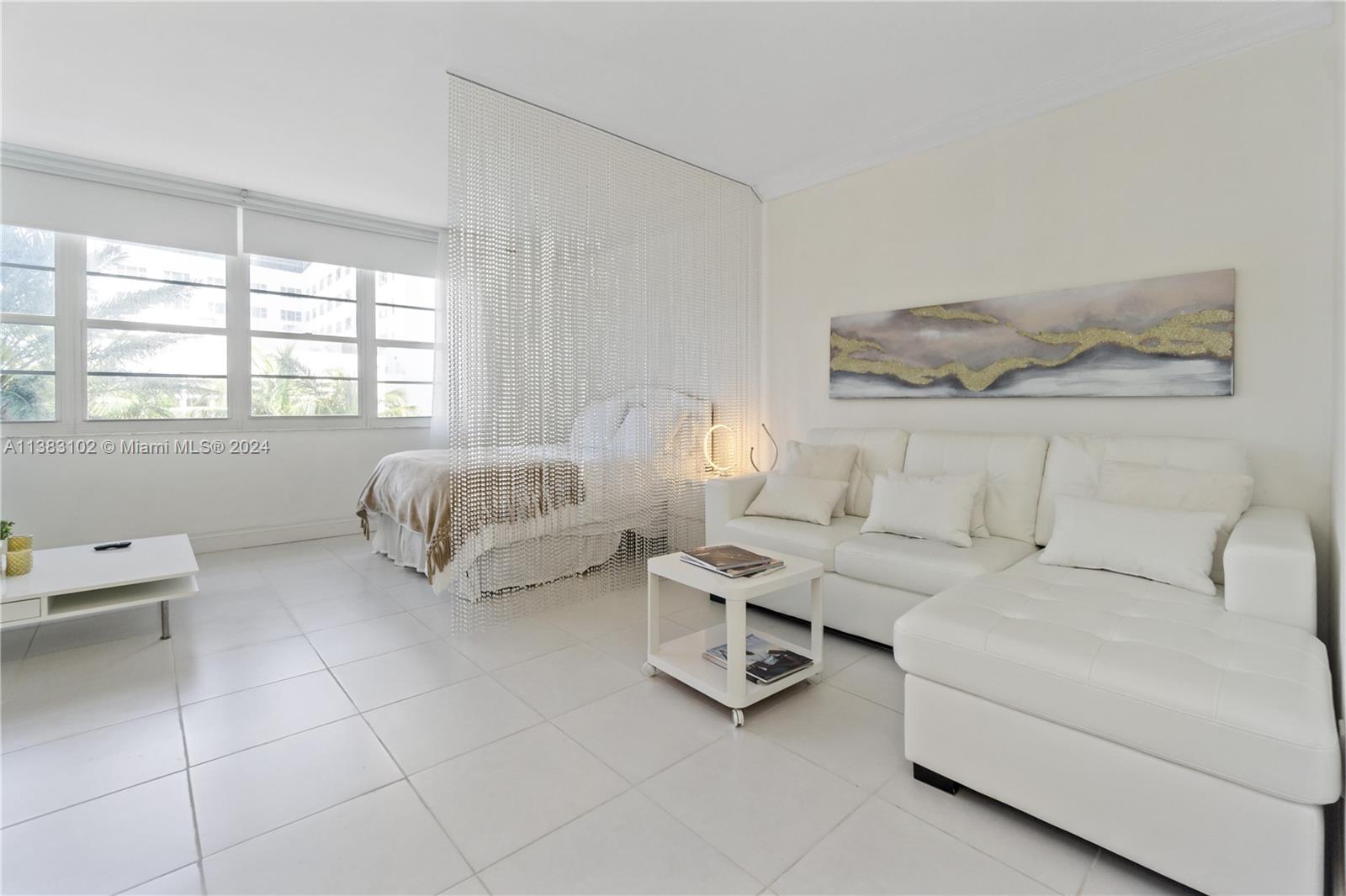 100 Lincoln Road, Unit 306 Miami Beach, FL 33139 - Photo 2 of 18 a living room with furniture and a window