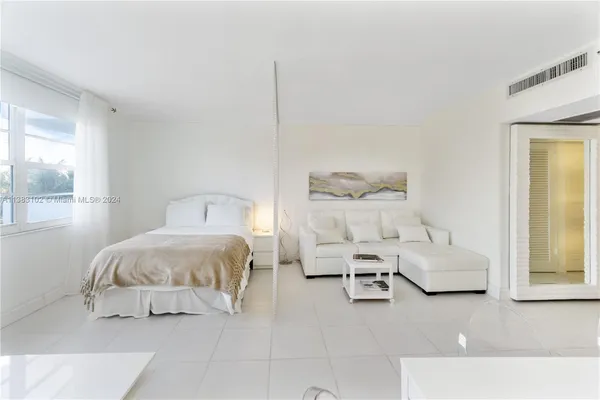 a bedroom with a bed and a night stand