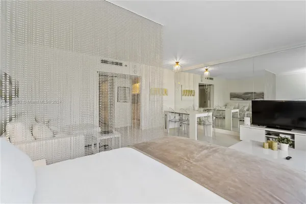 a living room with furniture a dining table and chairs