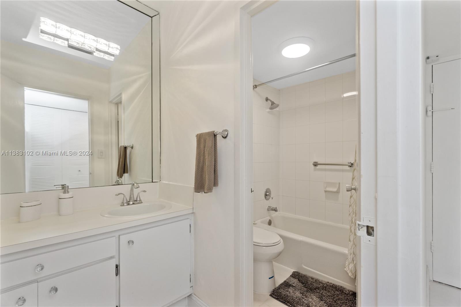 100 Lincoln Road, Unit 306 Miami Beach, FL 33139 - Photo 9 of 18 a bathroom with a sink a toilet and shower