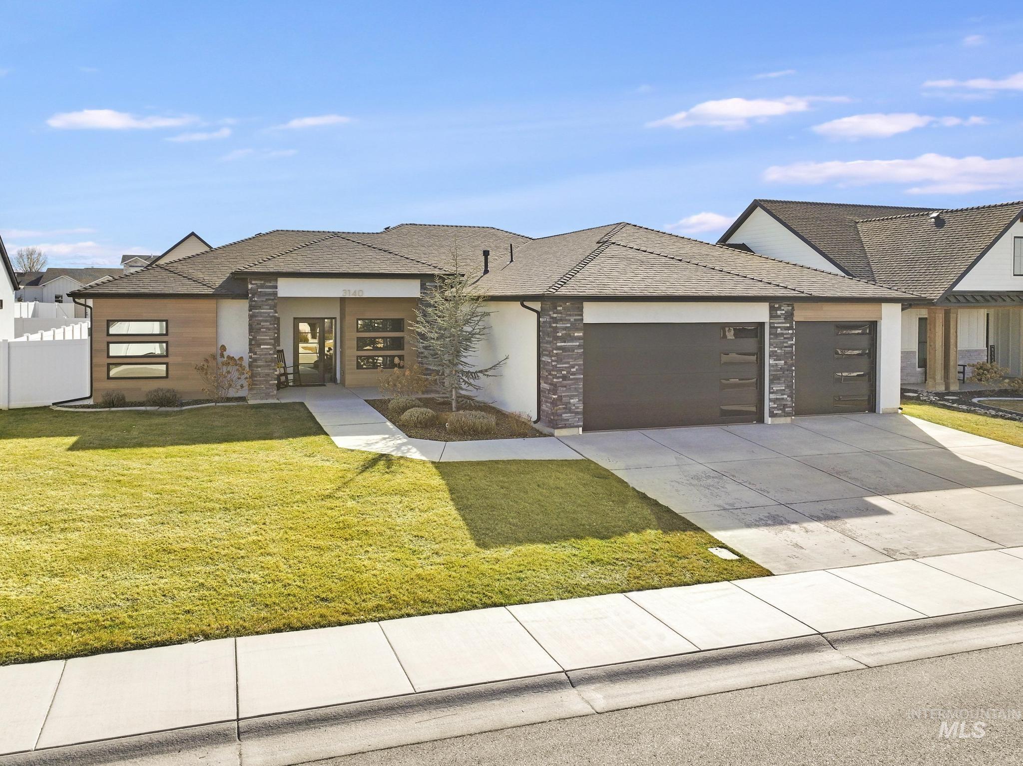 View of front of house featuring concrete driveway, an attached garage, roof with shingles, and stone siding